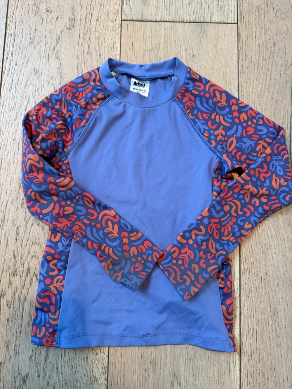 REI Kids Long-Sleeve Rashguard - Purple with Orange Patterned Sleeves.